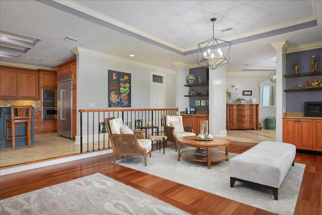 a living room with furniture and a chandelier