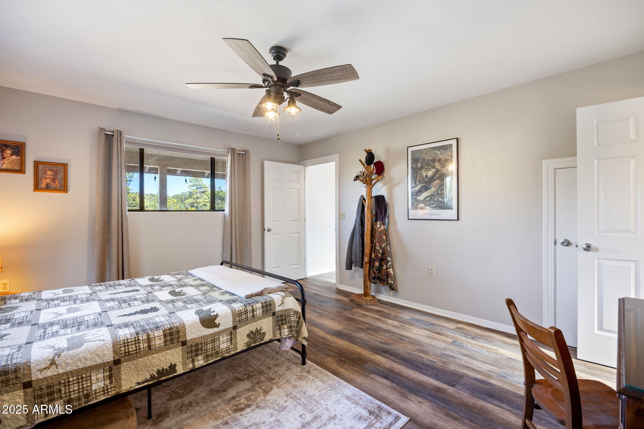 3684 Diamondback Drive Overgaard, AZ 85933 - Photo 12 of 36 a bedroom with a bed and a chandelier