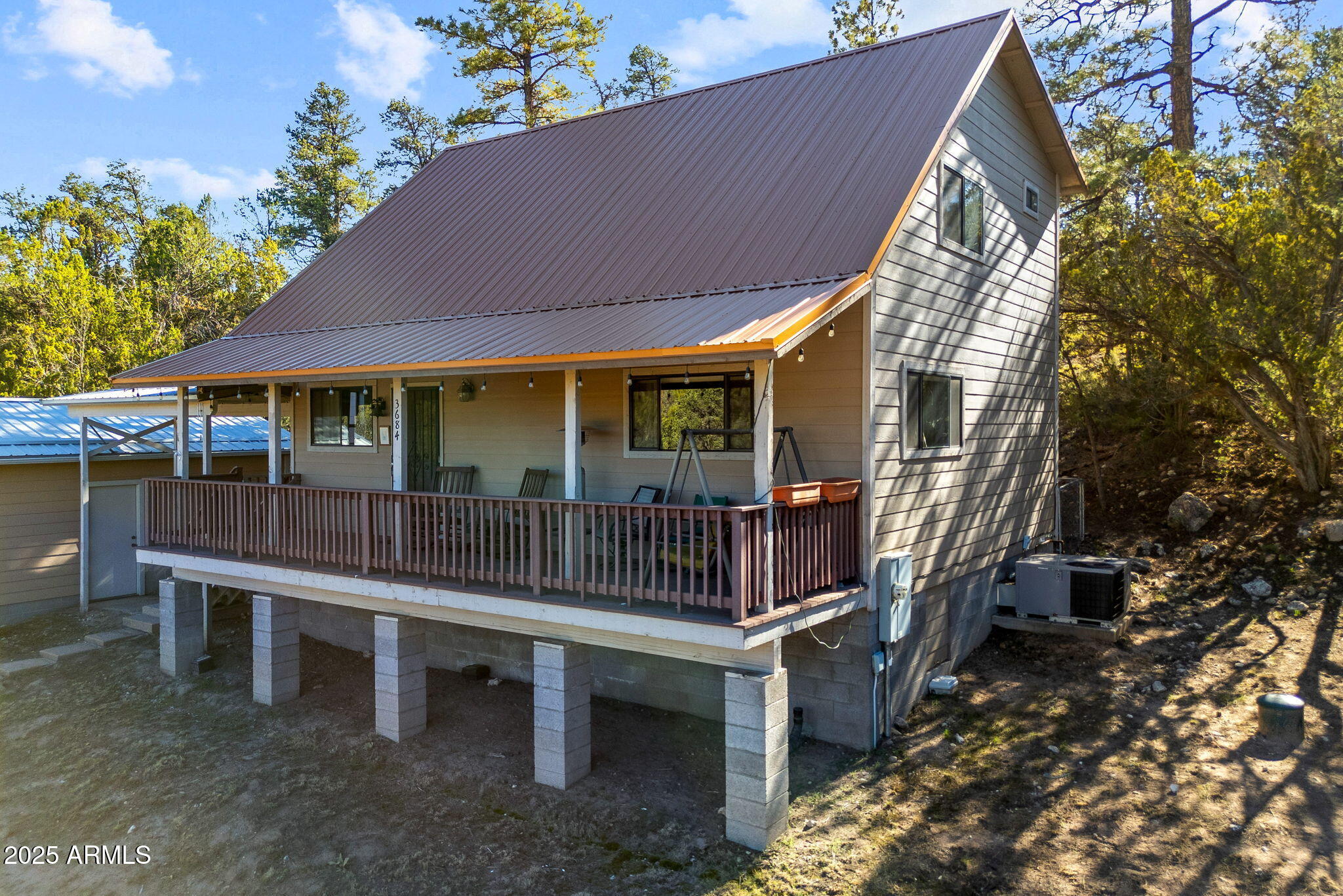 3684 Diamondback Drive Overgaard, AZ 85933 - Photo 2 of 36 a small house with a bench in front of it