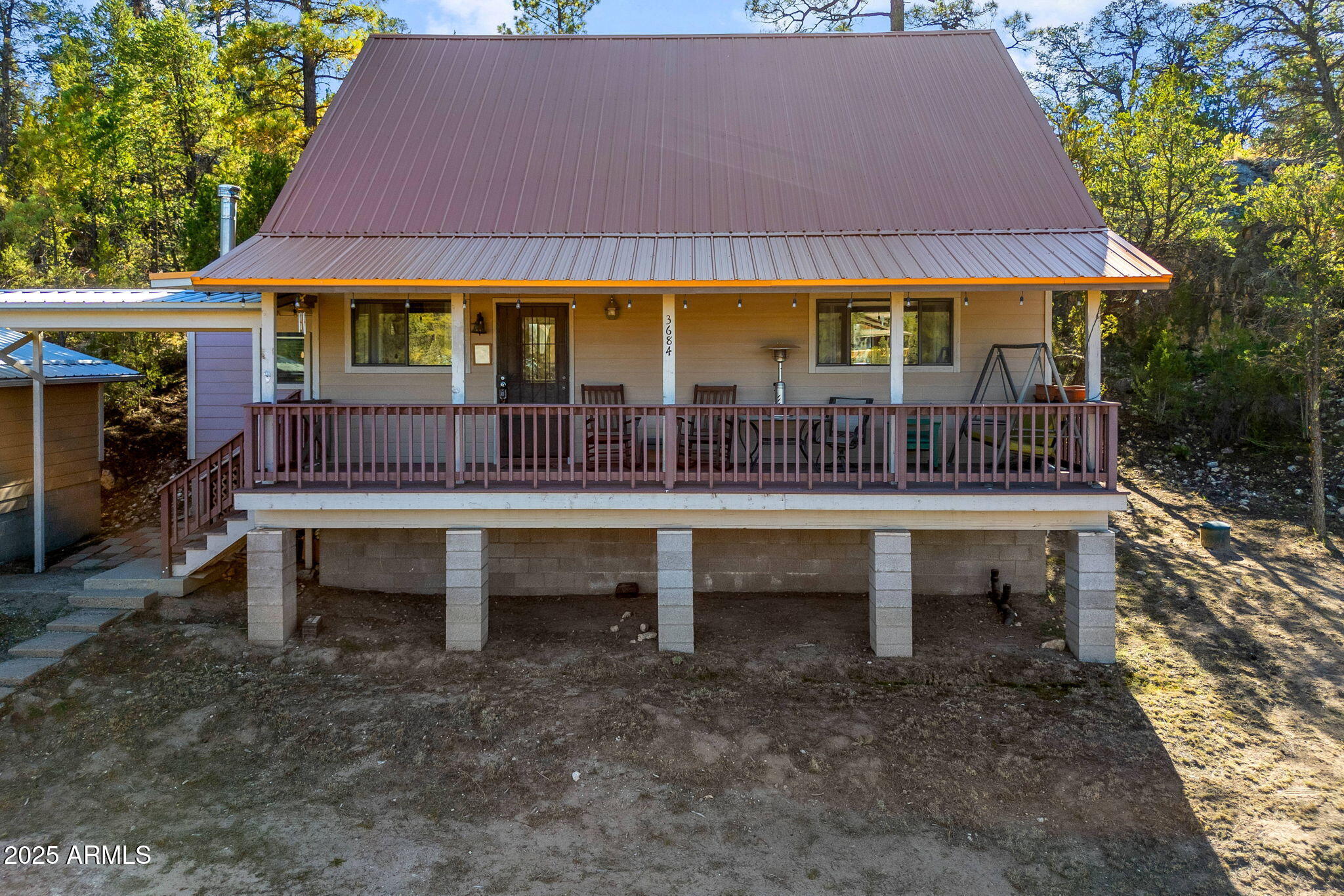 3684 Diamondback Drive Overgaard, AZ 85933 - Photo 32 of 36 a front view of a house with a porch