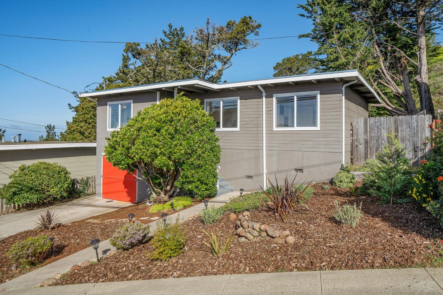 a front view of a house with garden
