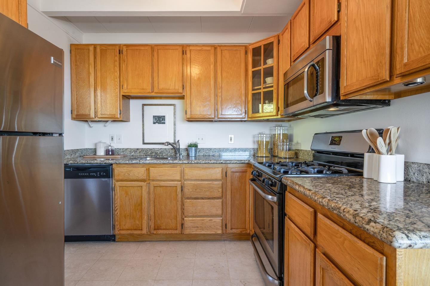 559 Manor Drive Pacifica, CA 94044 - Photo 13 of 38 a kitchen with stainless steel appliances granite countertop a stove sink and cabinets