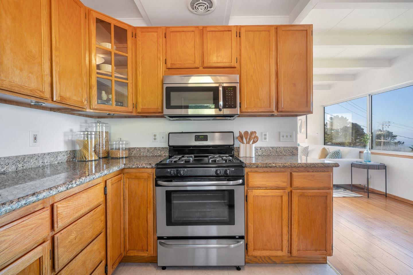 559 Manor Drive Pacifica, CA 94044 - Photo 15 of 38 a kitchen with stainless steel appliances granite countertop a stove a sink and a microwave