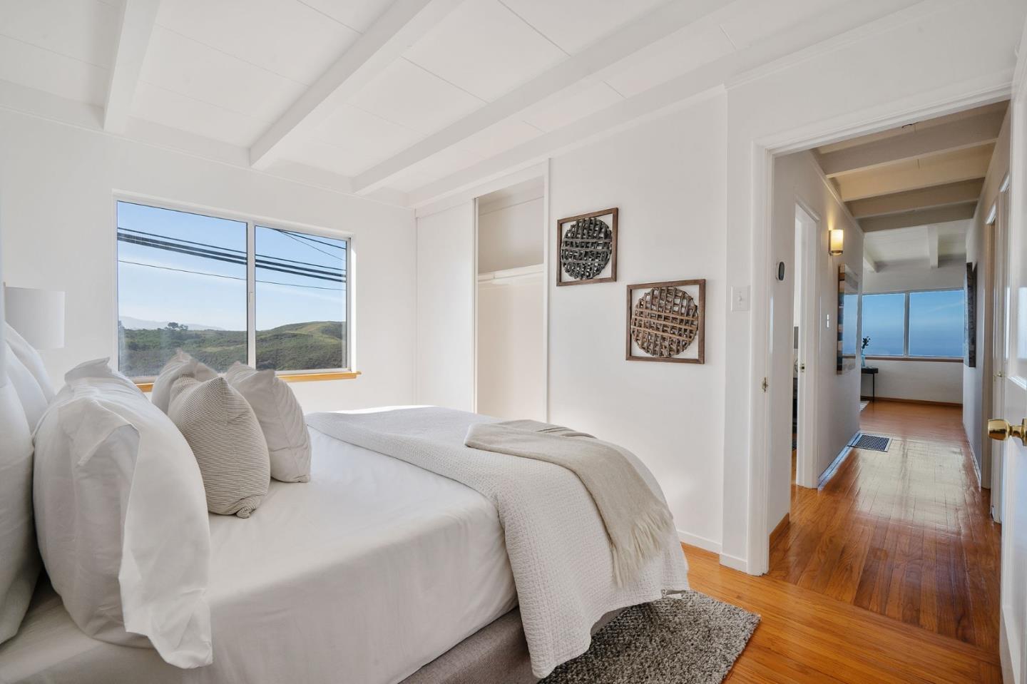 559 Manor Drive Pacifica, CA 94044 - Photo 22 of 38 a bedroom with a bed and a large window