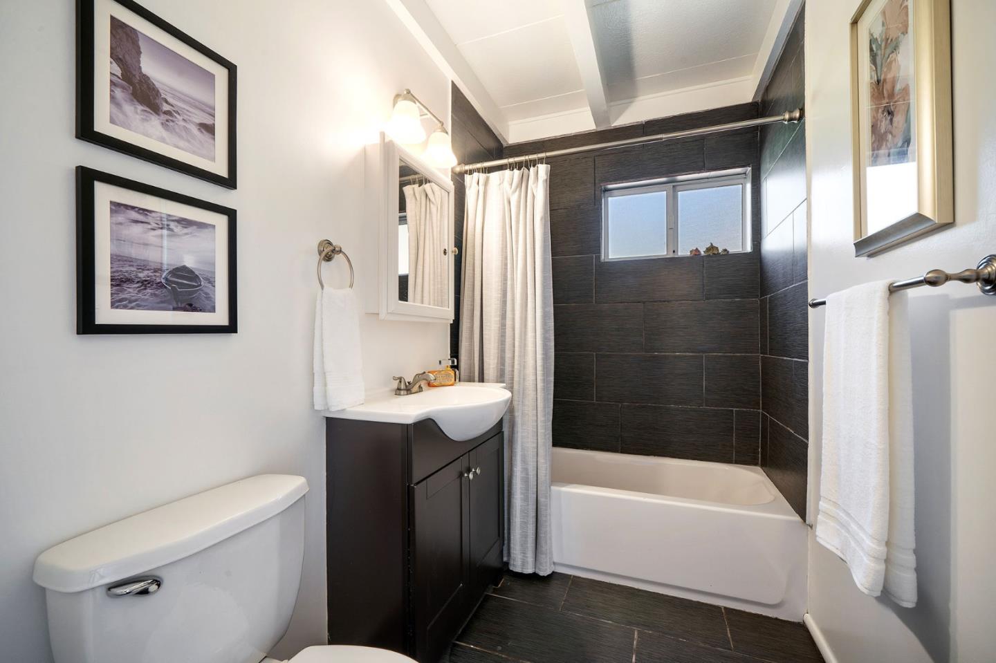 559 Manor Drive Pacifica, CA 94044 - Photo 28 of 38 a bathroom with a sink a toilet and shower