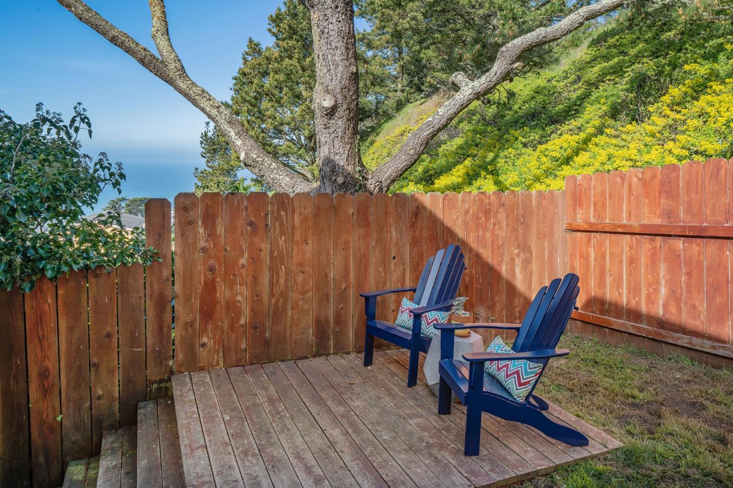 559 Manor Drive Pacifica, CA 94044 - Photo 34 of 38 a view of backyard with table and chairs and wooden fence