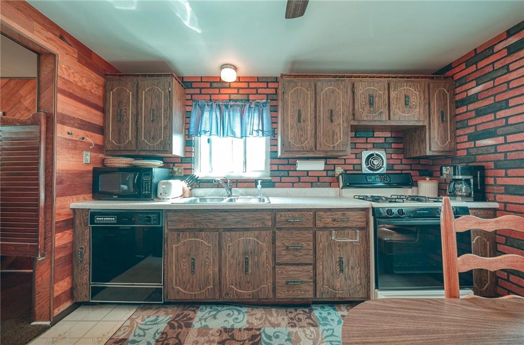 142 William Circle McKees Rocks, PA 15136 - Photo 6 of 23 a kitchen with stainless steel appliances granite countertop a stove a sink dishwasher and cabinets
