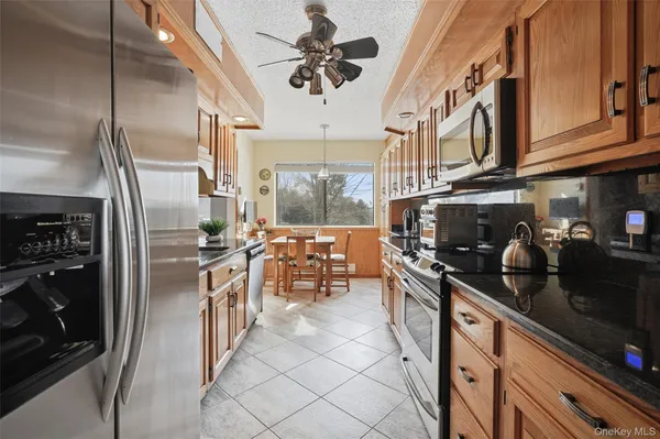 a kitchen with stainless steel appliances granite countertop a refrigerator and a stove