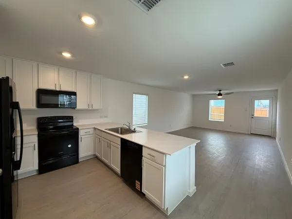 a kitchen with a sink dishwasher stove and refrigerator