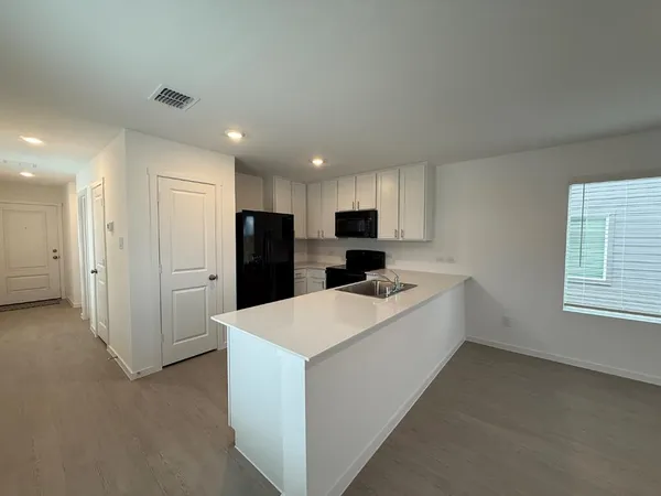 an empty room with a empty space and a ceiling fan