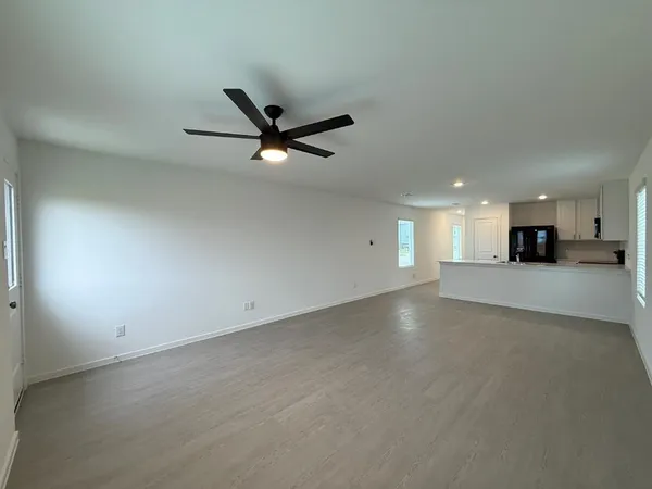an empty room with windows and closet