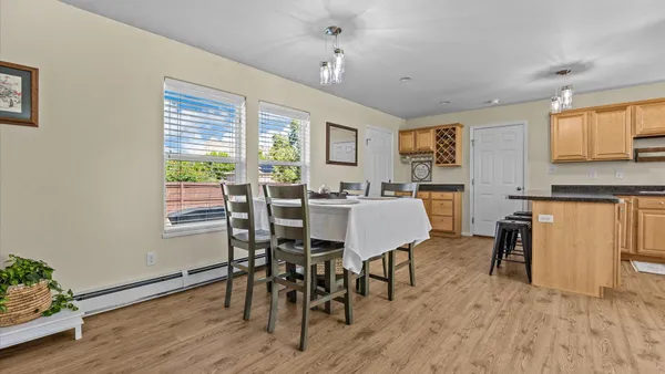 a view of a dining room with furniture window and wooden floor