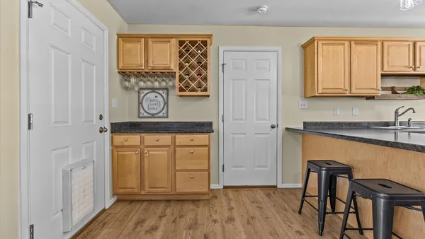 a view of kitchen with wooden floor and furniture