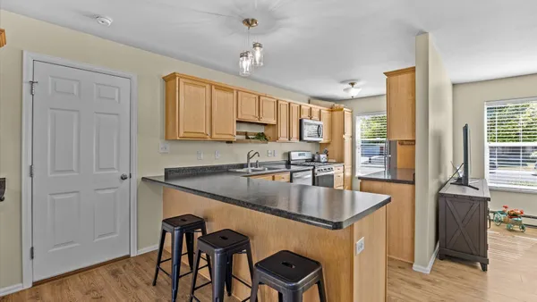 a kitchen with granite countertop a sink a center island and cabinets