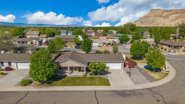 an aerial view of residential houses with outdoor space and street view