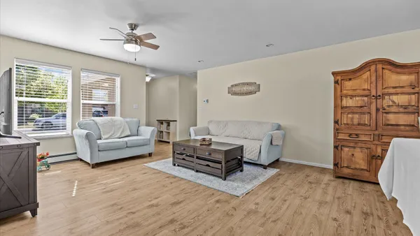 a living room with furniture and wooden floor
