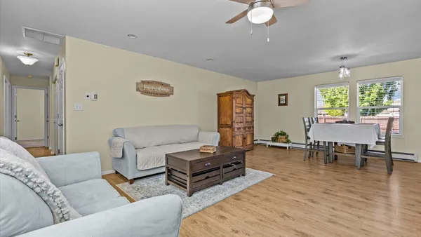 a living room with furniture and a wooden floor