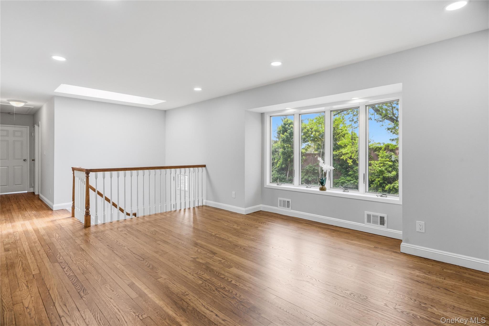 183 North Marginal Road Jericho, NY 11753 - Photo 7 of 28 Living room with View of Front Yard and Entrance to Hallway and Bedrooms with Wood Finished Floors