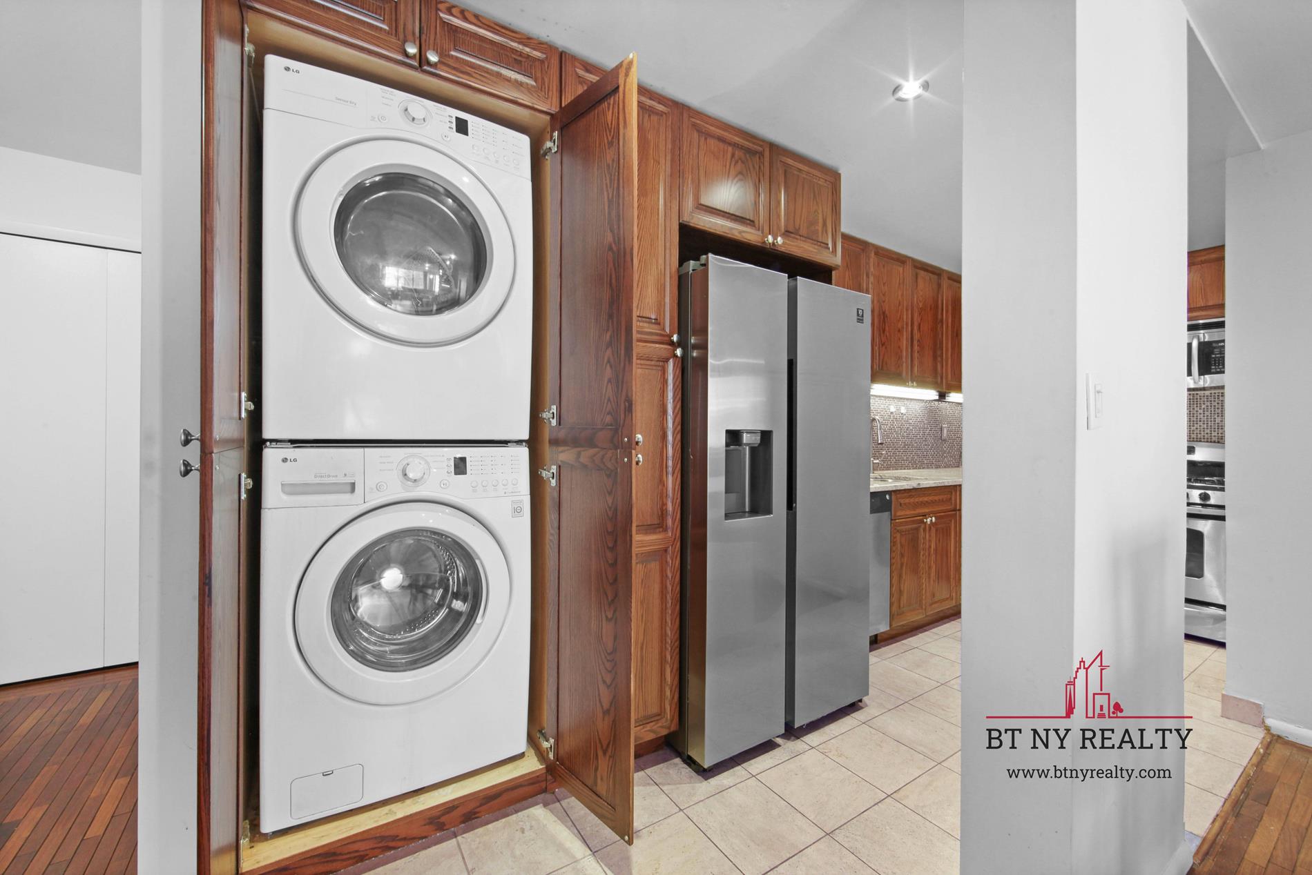 216-218 East 47th Street, Unit 4A Manhattan, NY 10017 - Photo 4 of 10 a view of a storage & utility room with washer and dryer