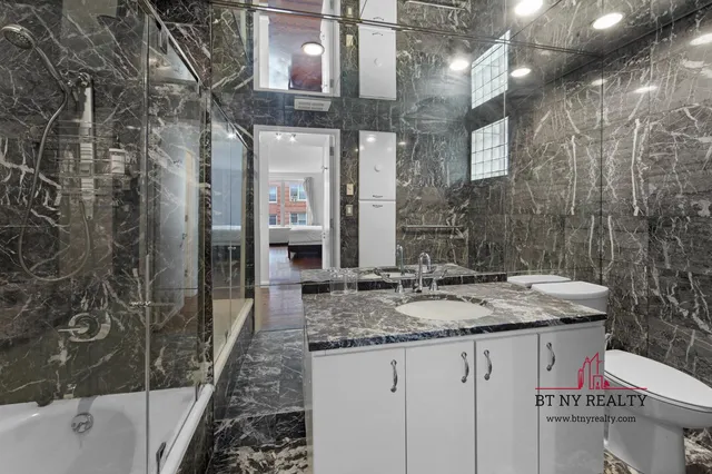 a bedroom with a bed chair and window