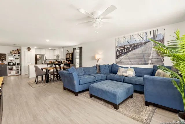 a living room with furniture and kitchen view