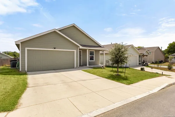 a front view of house with yard and green space
