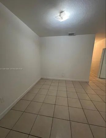 an empty room with a bench