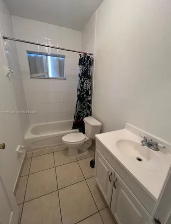 a bathroom with a sink a toilet and bathtub