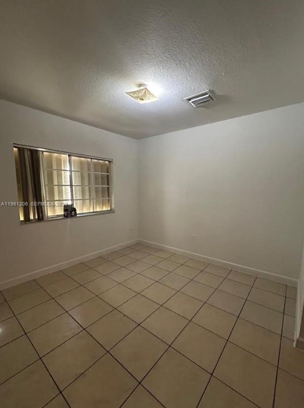 26540 Southwest 138th Avenue Homestead, FL 33032 - Photo 21 of 27 a view of an empty room and a window