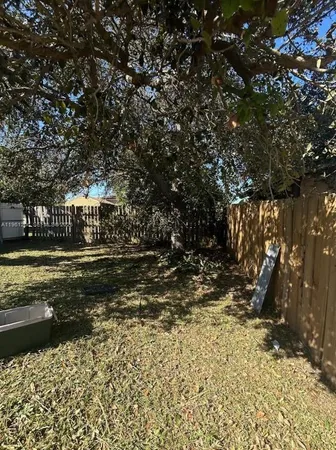 a view of house with backyard