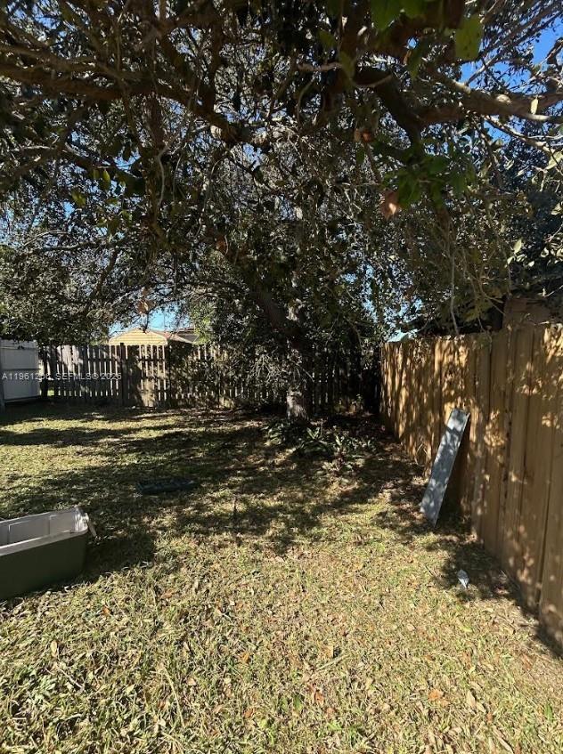 26540 Southwest 138th Avenue Homestead, FL 33032 - Photo 25 of 27 a view of a yard with plants and large trees