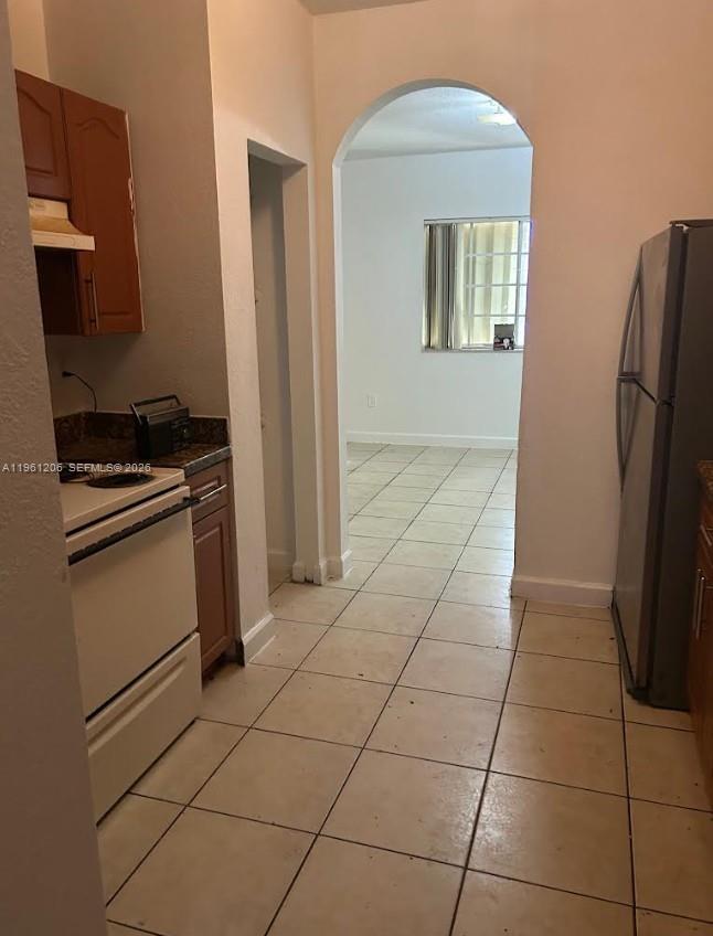 26540 Southwest 138th Avenue Homestead, FL 33032 - Photo 10 of 27 a kitchen with stainless steel appliances a refrigerator and a stove top oven