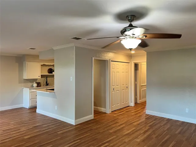 a view of a kitchen with stainless steel appliances a wooden floor