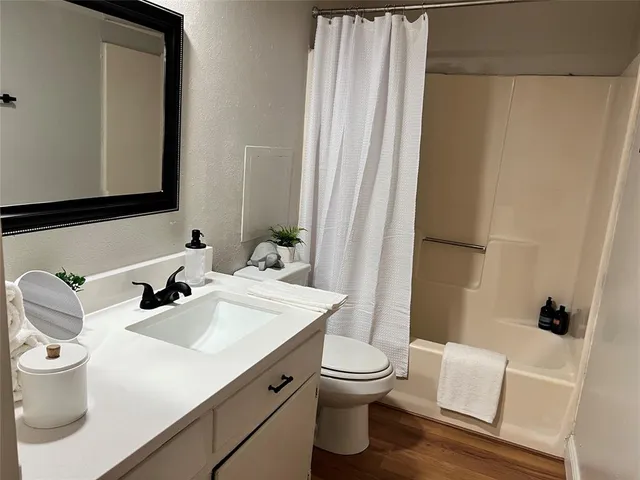 a bathroom with a sink toilet and shower
