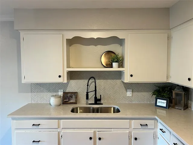 a kitchen with a sink and a stove