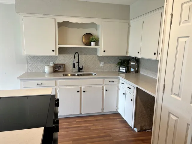 a kitchen with cabinets and window
