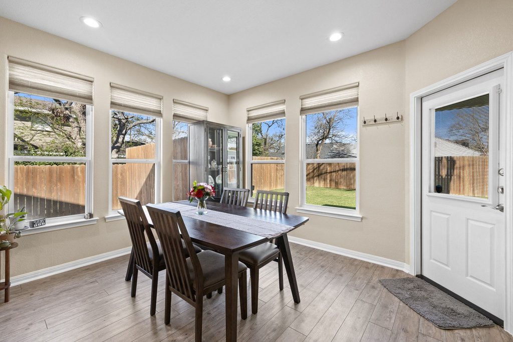 1720 Prather Street Taylor, TX 76574 - Photo 14 of 34 a view of a dining room with furniture large windows and wooden floor
