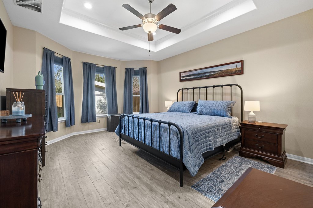 1720 Prather Street Taylor, TX 76574 - Photo 17 of 34 a bedroom with a large bed and a chandelier fan