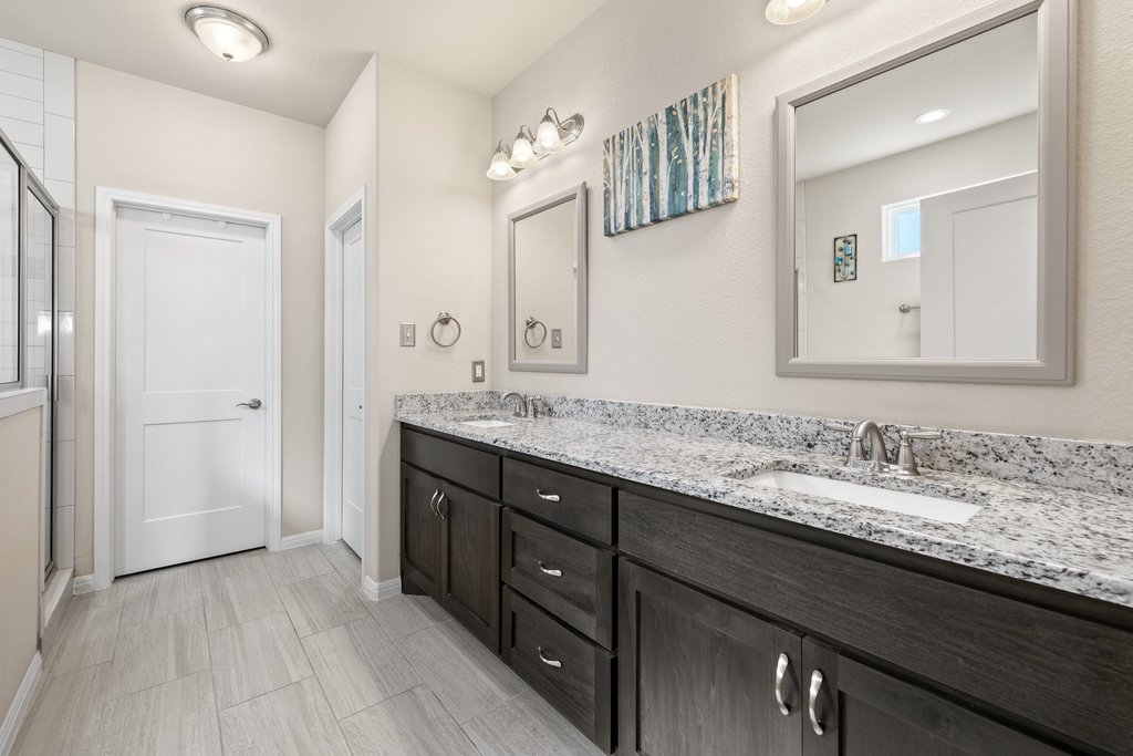 1720 Prather Street Taylor, TX 76574 - Photo 19 of 34 a bathroom with a granite countertop sink and a mirror