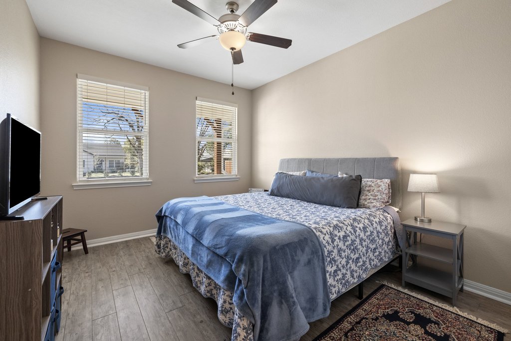 1720 Prather Street Taylor, TX 76574 - Photo 22 of 34 a bedroom with a bed and a flat screen tv