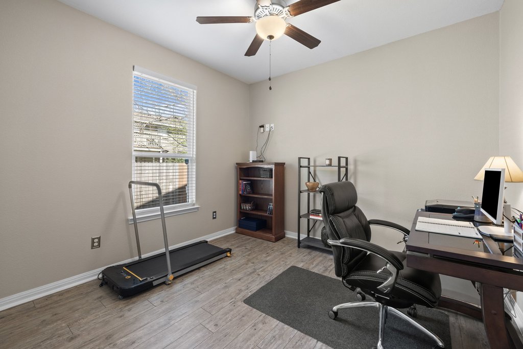 1720 Prather Street Taylor, TX 76574 - Photo 24 of 34 a view of a workspace with furniture and a window
