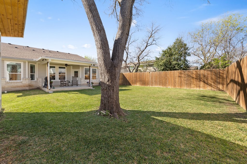 1720 Prather Street Taylor, TX 76574 - Photo 31 of 34 a view of a house with a yard patio and a tree