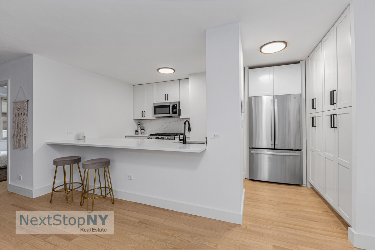 363 East 76th Street, Unit 2L Manhattan, NY 10021 - Photo 2 of 10 a kitchen with stainless steel appliances a refrigerator sink and cabinets