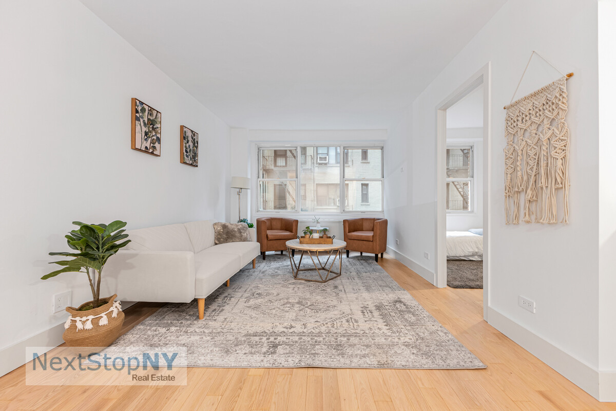 363 East 76th Street, Unit 2L Manhattan, NY 10021 - Photo 3 of 10 a living room with furniture and a rug
