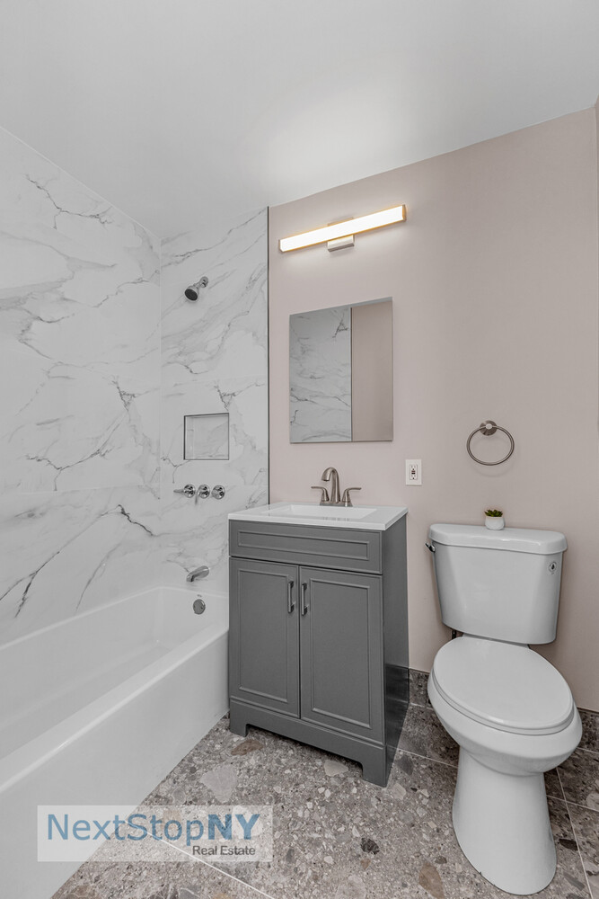 363 East 76th Street, Unit 2L Manhattan, NY 10021 - Photo 7 of 10 a bathroom with a sink a toilet and bathtub