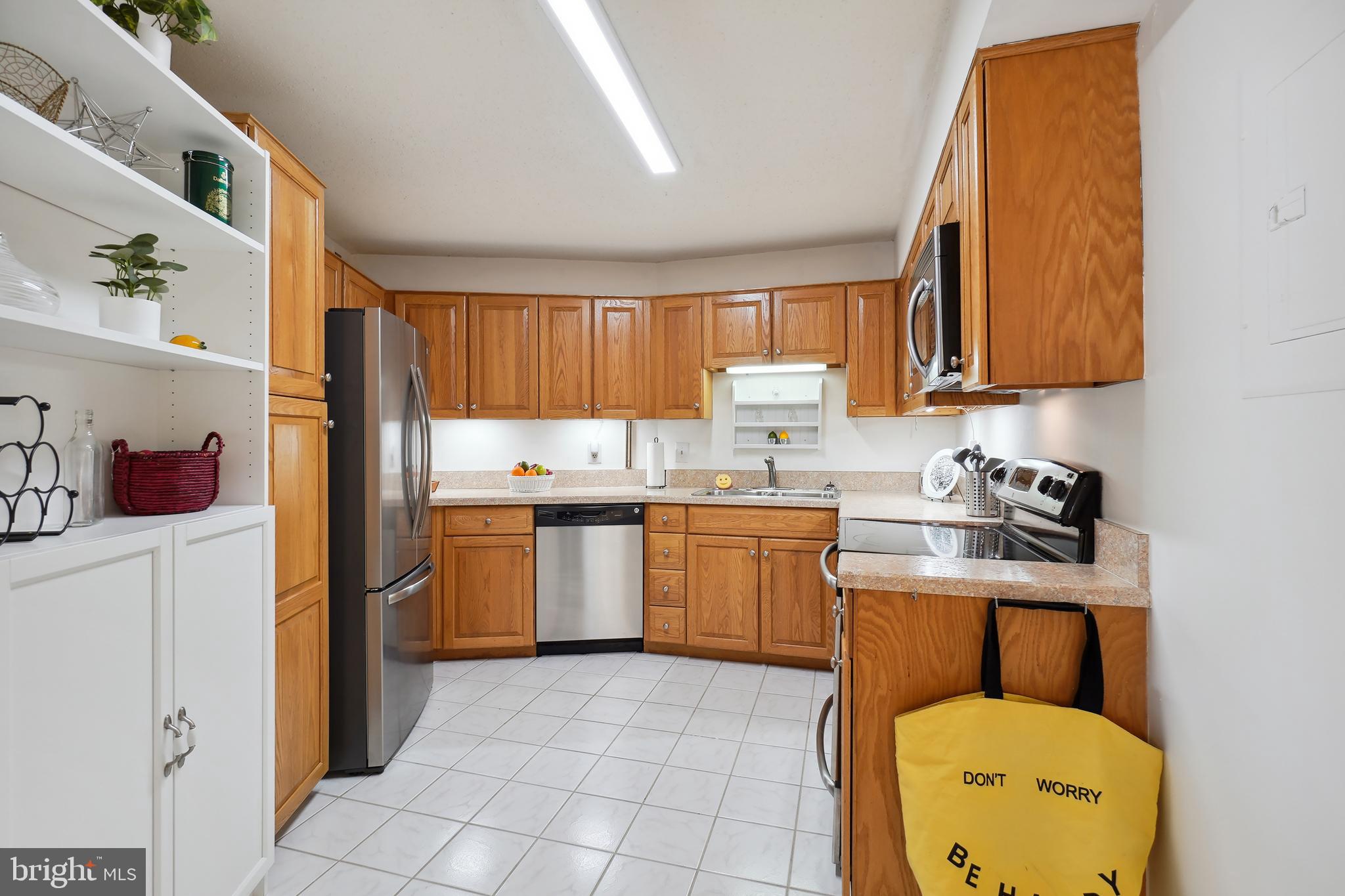 15100 Interlachen Drive, Unit 4517 Silver Spring, MD 20906 - Photo 13 of 42 a kitchen with a refrigerator sink and cabinets