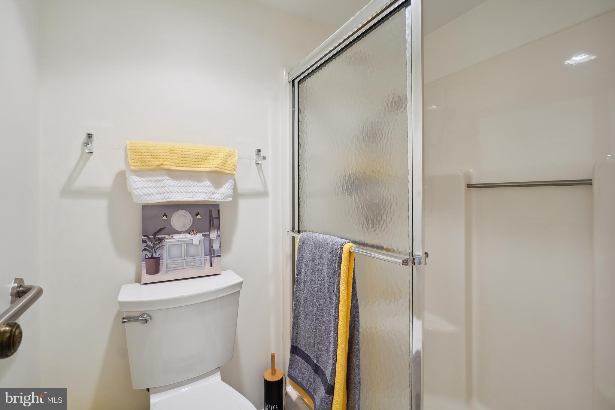 15100 Interlachen Drive, Unit 4517 Silver Spring, MD 20906 - Photo 23 of 42 a bathroom with a shower sink and mirror