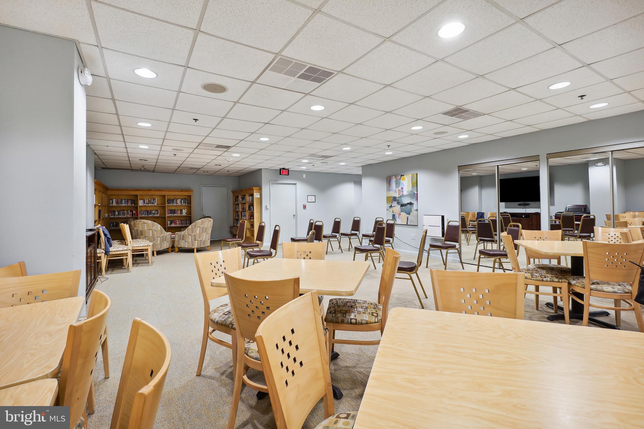 15100 Interlachen Drive, Unit 4517 Silver Spring, MD 20906 - Photo 29 of 42 a large room with lots of table chair and couches