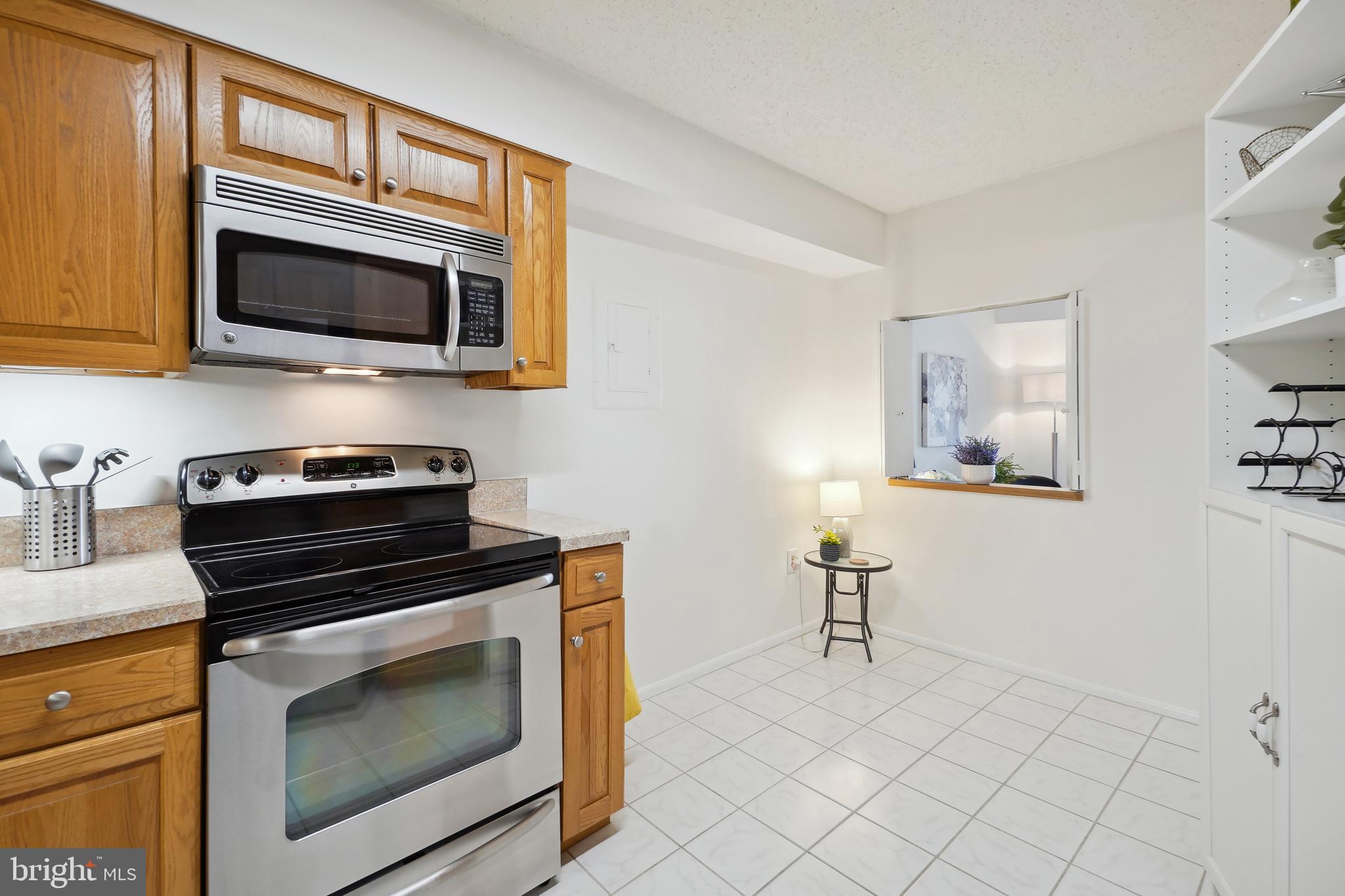 15100 Interlachen Drive, Unit 4517 Silver Spring, MD 20906 - Photo 6 of 42 a kitchen with stainless steel appliances a stove microwave and sink