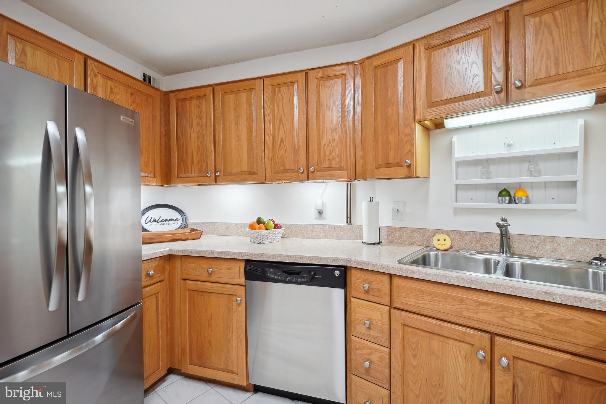 15100 Interlachen Drive, Unit 4517 Silver Spring, MD 20906 - Photo 8 of 42 a kitchen with stainless steel appliances granite countertop a refrigerator sink and cabinets